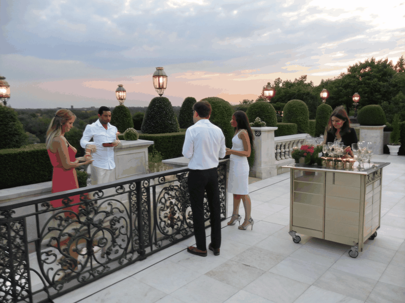 Guests raising crystal champagne flutes during an afternoon terrace reception